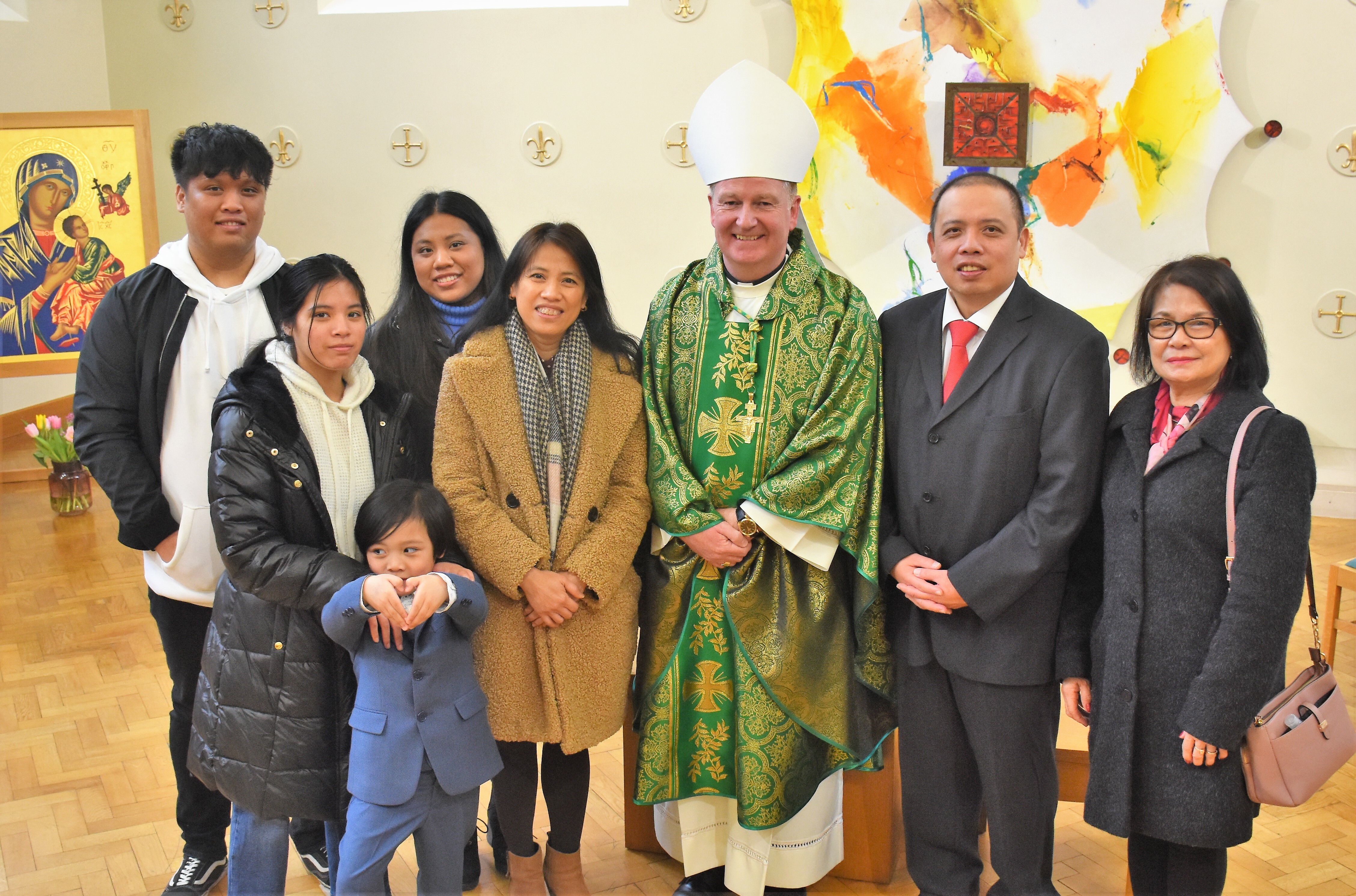 230129-Bishop-Dempsey-with-Norvil-Caguioa-R-and-his-wife-Antoinette-L-together-with-members-of-their-family-after-Norvil-received-the-Ministry-of-Acolyte.jpg#asset:11433